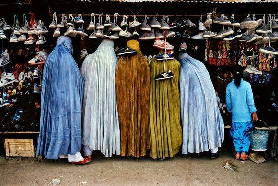 Afghan women at shoe store’, 1992. | 24 Striking Pictures Of Afghanistan By Photojournalist Steve McCurry- Balkan War was raging on